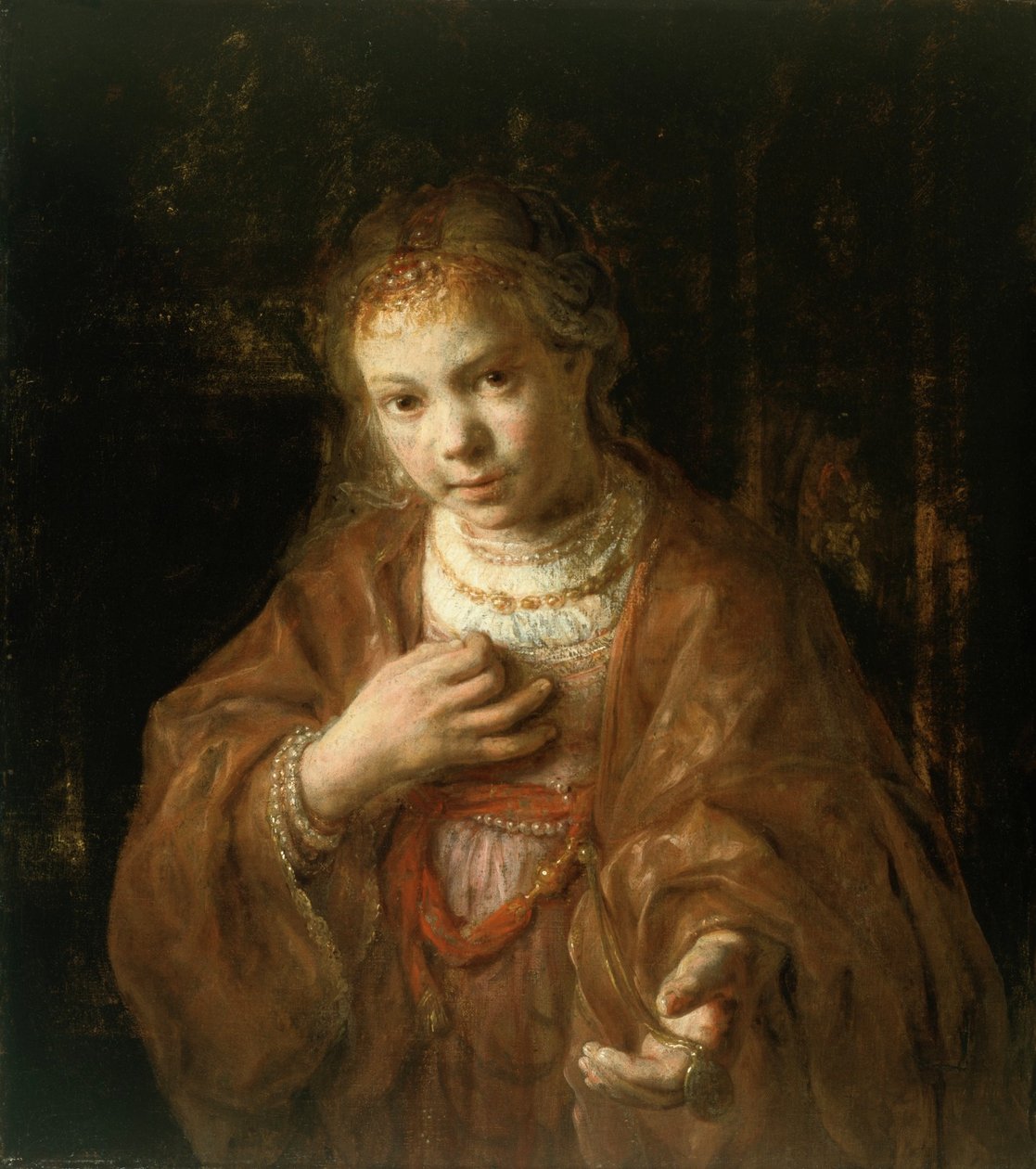 Jong meisje met een medaille door Rembrandt
